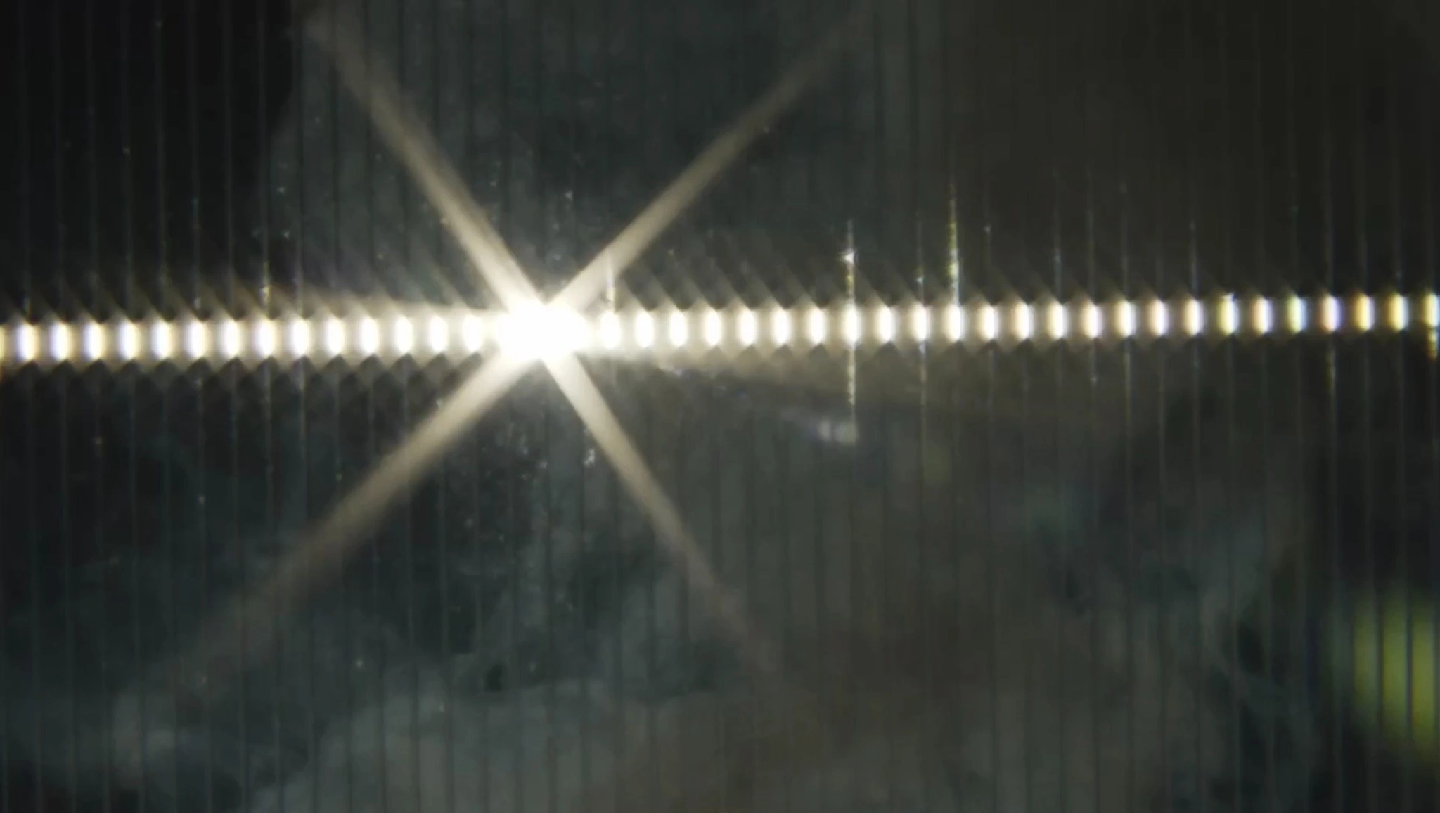 A starburst of light reflected across a dark textured surface