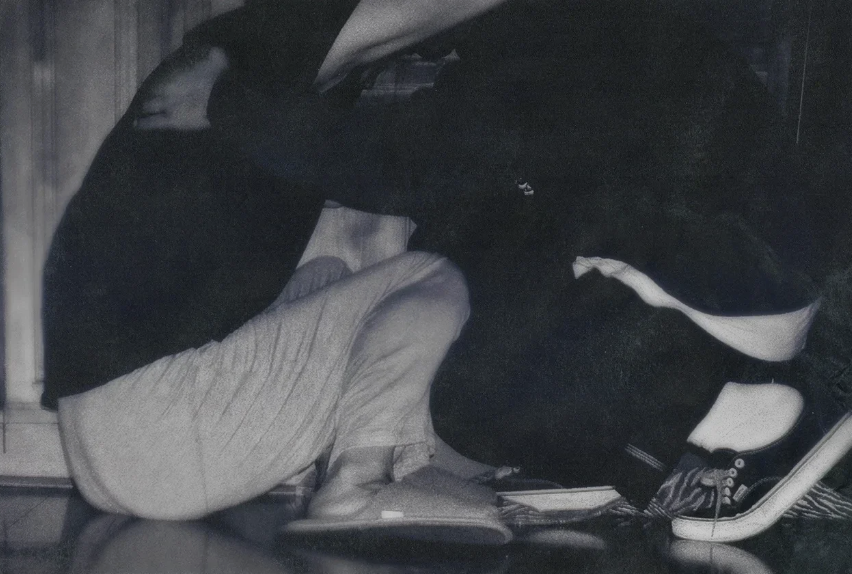 Artwork from Sweet Boy showing a boy crouched at home